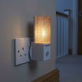 11 cm night light plugged in on a landing
