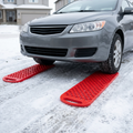 Both red traction mats positioned at the front tyres on snow