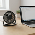 Compact 15 cm USB fan beside a laptop on a desk