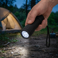 Compact rubber torch being used at a campsite