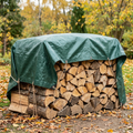 Dark green tarpaulin protecting a woodpile