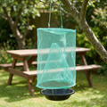 Fly catcher hanging from a tree near a garden picnic bench