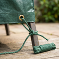 Green utility rope securing a garden cover