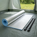Insulated camping mat partially unrolled inside a tent
