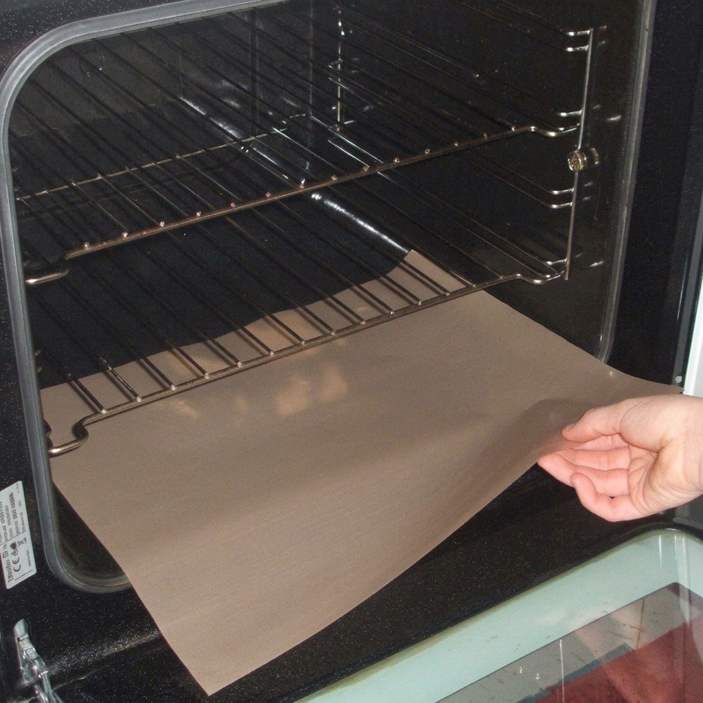 Reusable oven liner being placed in a cold oven