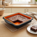 Silicone square cake pan with brownies in a kitchen