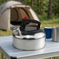 Stainless steel kettle on a campsite table