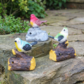 Whistling bird ornaments on a garden ledge